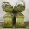 Pair of swag urns on decorative plinths